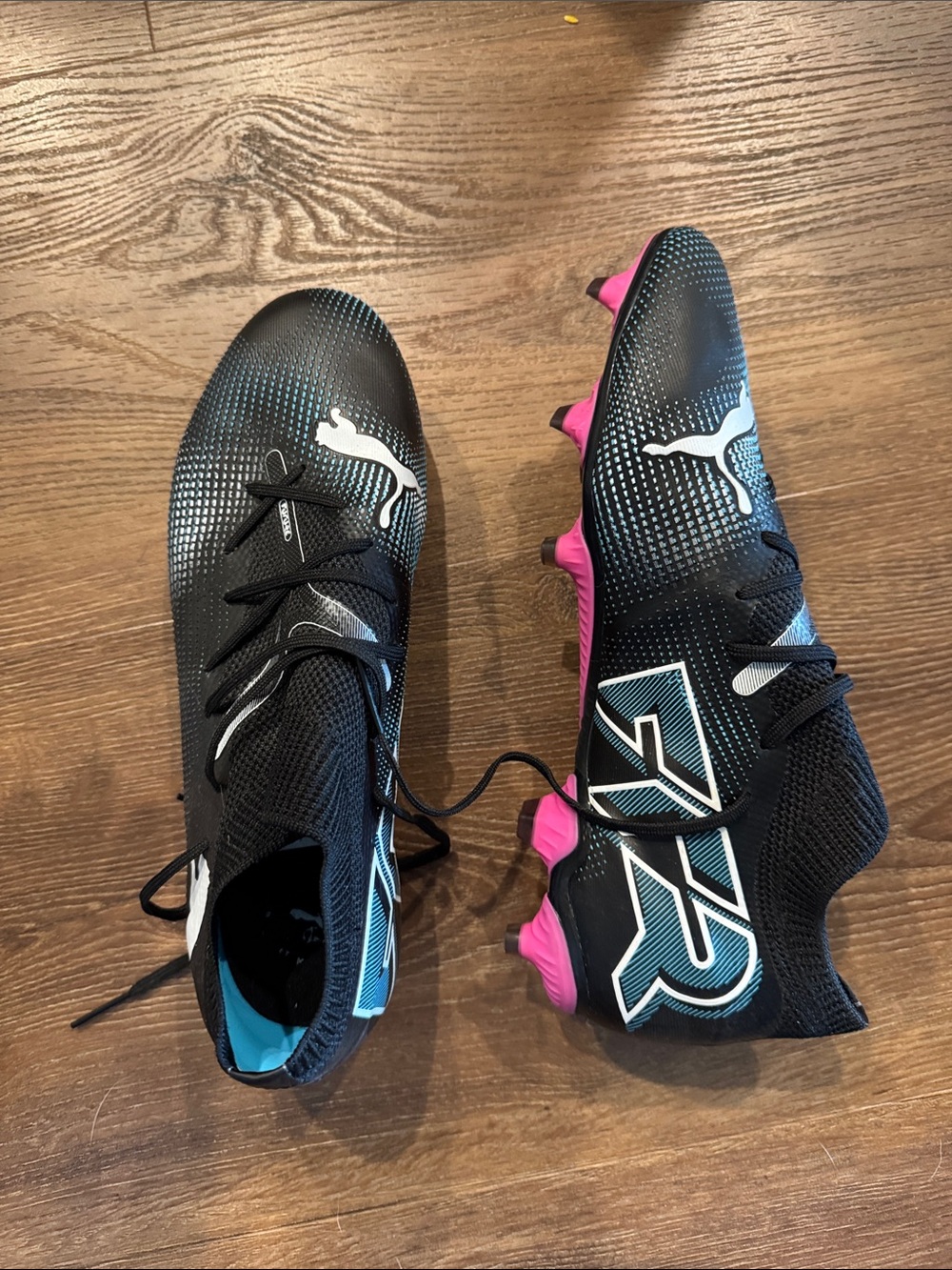 Puma Black Soccer Cleats with Pink Studs and Teal Accents